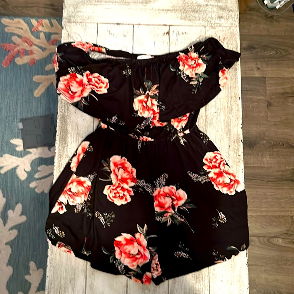 Small black floral romper. New without tags. Never worn.
